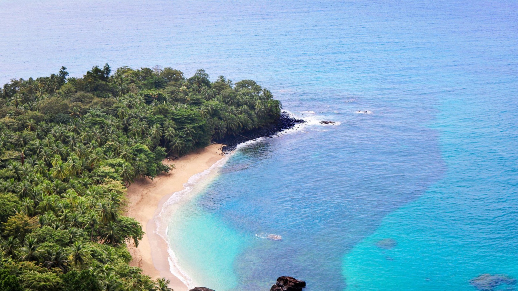 Aerial view of a forested bay on São Tomé