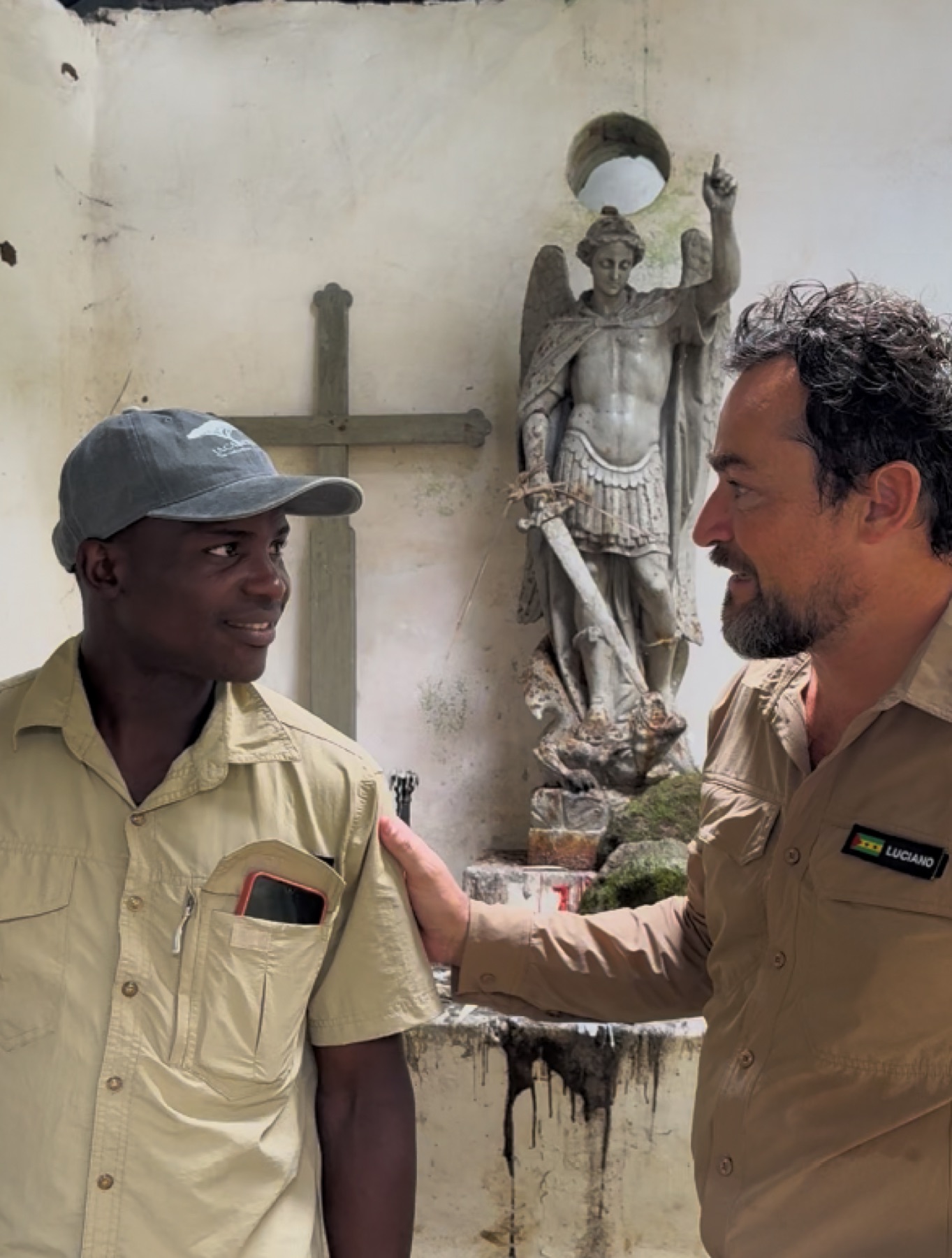 Luciano with a companion beside the statue